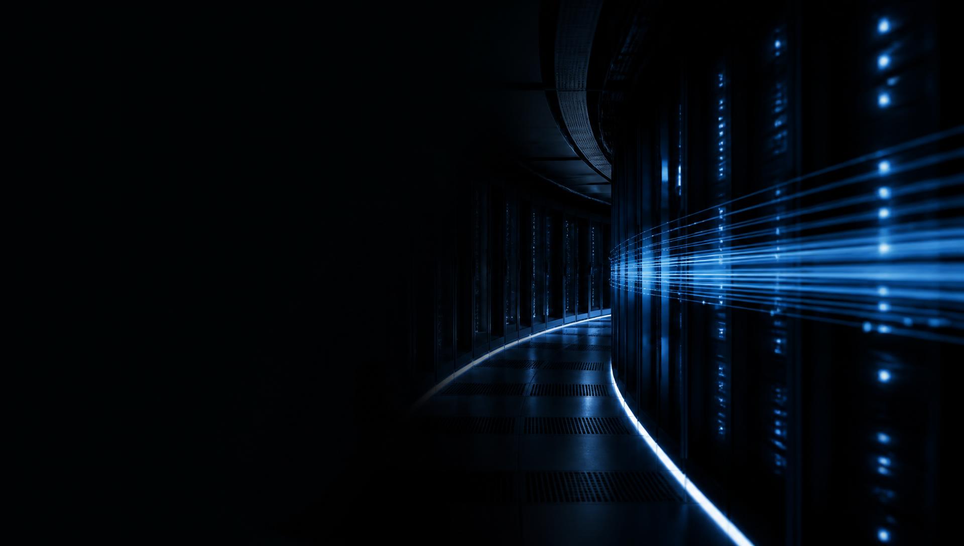 Dark data center corridor with blue fiber-optic light streaks